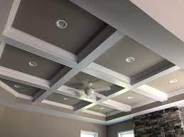 A kitchen featuring a stunning coffered ceiling lighted by recessed lights and pendant lights. Coffered Ceiling With Crown Molding And Recessed Lighting In Each Coffer Coffered Ceiling Ceiling Molding Ceiling