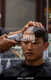U.S. Marine Corps officer candidates from Alpha and Delta Company, receive  their initial haircuts during Officer Candidates School (OCS), at Marine  Corps Base Quantico, Va., June 26, 2021. Candidates receive routine  haircuts to maintain hygiene and ...