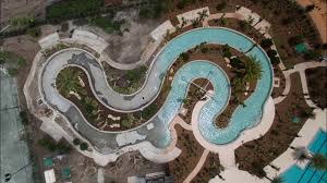 Upper and lower pools make the most of the organic slope of the backyard. Lazy River Swimming Pool Surface Installation Youtube