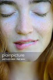 Young woman biting her lips