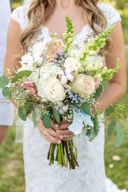 What kind of bouquet has a rhinestone brooch? Textured Ivory Blush And Green Bridal Bouquet