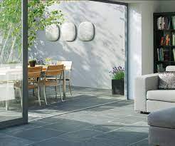 A house built in a row but larger in size than a terraced house, often having more than two storeys. Using The Same Flooring Throughout Softens The Threshold Outside Flooring Slate Patio Patio Flooring