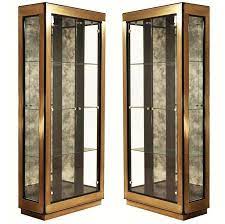Each curio cabinet has shelving and class panels for easy viewing. Two Modern Black Lacquered Brass Curio Display Cabinets By Mastercraft For Sale At 1stdibs