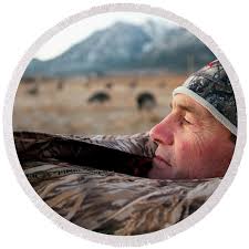 A Hunter Pokes His Head Out Of A Blind Shower Curtain by Corey Rich