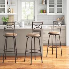 This kitchen island has the sort of loosely rustic flair and jeweled forest green hue that will fit in nicely in any space and credit: Andover Mills Basche Swivel Bar Stool Reviews Wayfair