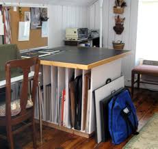 After struggling and damaging too much of our inventory, we came up with a. Vertical Storage With Work Top Top Great For Matting Or Paper Cutter Art Studio Storage Art Studio At Home Art Studio Space
