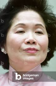 Image of Hong Kong Chief Secretary Anson Chan looks up during a