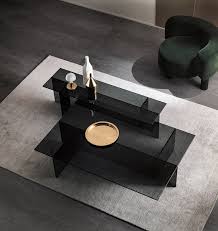 Del mar dos coffee table, smoked grey glass, oval limited edition by mtharu american modern gun metal and brass, smoked glass coffee table, karl springer rosa side table with solid and cast bronze details with a smoked glass top nesting coffee tables in blackened steel and gray glass, by force/collide, 2019 Smoked Glass A Classic From The 70s
