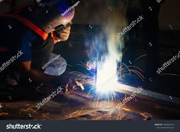 Welder Industrial In The Factory With Smoke From Welding Job Industrial Worker With Steel Welding Tool Royalty Free I Welding Jobs Industrial Factory Welders