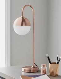 It comes equipped with a 2 prong outlet seated in the base for use to charge mobile phones, handheld games, tablets, and other small electronics. This Striking Rose Gold Desk Lamp Features A Contrasting White Frosted Glass Globe Ideal For Use In A Living Roo Table Lamps Living Room Lamp Side Table Lamps