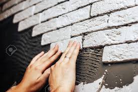 Maybe you would like to learn more about one of these? Man S Hands Glue Decorative Brick On A Wall Smeared With Cement Stock Photo Picture And Royalty Free Image Image 87299095