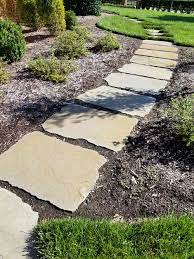 These large stepping stones integrate nicely with the landscape creating a natural and welcoming entrance. Blue Stone Stepping Path H G Hertzler George Williamsburg