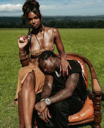 Asake shines in new photos with model and art director Mariana Jaguite for  his "MCBH" music video. Filmed in the picturesque English countryside,  featuring medieval castles, charging bulls, and a cinematic touch,