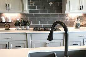 The cool white finish of the boards catches the incoming light from the windows, leaving the space bright, fresh, and spacious while the nicely contrasting muted colors on the flooring further enhances the aesthetic. What Color Hinges And Knobs For White Cabinets Home Decor Bliss