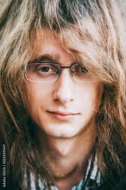 Portrait Of Rock Star Young Man Guy With Glasses And Long Hair Stock Photo 