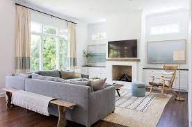 White Wall Wooden Floor Grey Couch White Carpet Sitting Room Ideas Fireplace Printed Throw Pillows Living Room Decor Living Room Stands Elegant Living Room