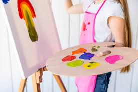 Oil paints will stain a wood palette if left on it too long. Free Photo Close Up Of A Girl Painting On Canvas Holding Multicolored Wooden Palette In Hand