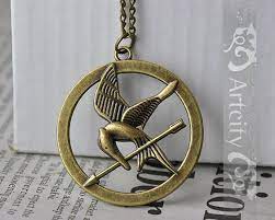 Items Similar To The Hunger Games Pendant Inspired Mockingjay Necklace On Sale On Etsy Hunger Games Necklace Hunger Games Hunger Games Mockingjay