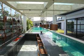 20 Mesmerizing Tropical Swimming Pool Designs That Will Take Your Breath Away Indoor Swimming Pool Design Pool House Designs Indoor Outdoor Pool