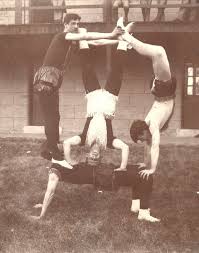 vmi gymnastics team performing a stunt