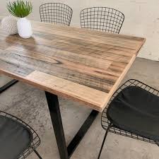 Dining table with a round pedestal base and round wooden top. Recycled Timber Dining Table The Timber Shack