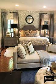 This Master Bedroom Is Complete With Geometric Wallpaper A Loveseat And Plush Throw Pillows Making It Both Comfortable And Livable Home Home Decor Room