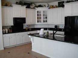 Dramatic black appliances make gray cabinets stand out. White Cabinets With Black Appliances Antique White Kitchen Cabinets Antique White Kitchen Black Appliances Kitchen