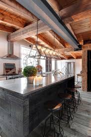 Clerestory windows and double height panes create high views up into the trees that grow around the grounds of the home, and which provide inspiration for the natural palette used within. Modern Rustic House Interior Design Novocom Top
