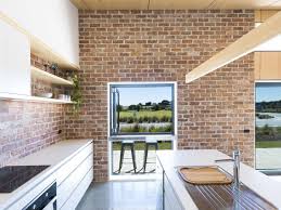 White glass tile is reflective and shiny and has an apparent depth that adds extra interest to a backsplash under white cabinets. Best 24 Modern Kitchen Brick Backsplashes White Cabinets Design Dwell