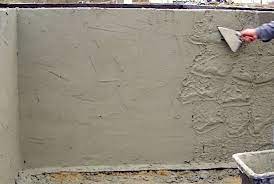 Builder worker plastering exterior wall. Types Of Plaster Finishes And External Rendering For Buildings