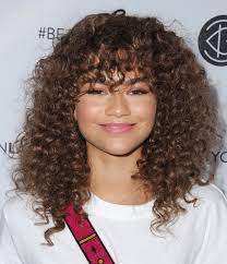 Frizzy hair often looks thick which is not a bad thing after all, but in order to look more put together, try pulling it back in simple updos and half up hairstyles. How To Style Naturally Curly Hair