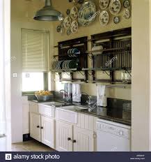 plate racks and white sinks stock photo