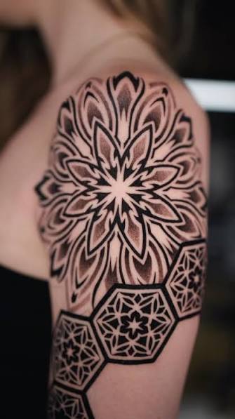 This geometric floral sleeve blends dotwork, negative space, and mandala symmetry for a striking contrast on the upper arm and shoulder. A true fusion of organic and structured yet to be completed by ...