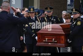 The casket of McHenry County Sheriff's Deputy Jacob Keltner is carried from  Woodstock North High School after the funeral for the fallen officer in  Woodstock, Ill.