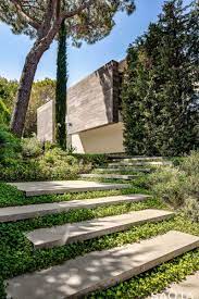 Landscaping Ideas Welcoming Visitors To This Modern House Is An Entrance Path With Concrete Steps That Lead From Landscape Stairs Landscape Design Landscape