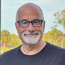 This is Heidi Tompkins, ROI Office Interiors operations specialist,  removing snow from a roof