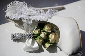 Artificial wedding flowers we purchase in large volume to pass the savings on to you. Photo Closeup Of Beautiful Wedding Buttonhole Bouquet Of Fresh Small Pastel Color Tea Roses Flowers Buds Green Leaves Decorated With Bow Crystals And Bride Shoe On White Background Horizontal Picture Stock Photo