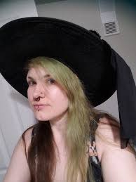 Origin of the pointy witch's hat?