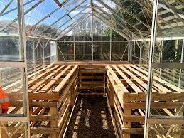 The authors sealed the plywood walls. Diy Greenhouse Staging From Used Pallets Woodworking