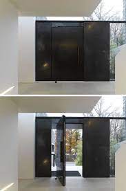 Our black steel doors are custom crafted to fit the style and particular needs of a wide range of building types. This Large Pivoting Black Steel Door Definitely Makes A Statement Steel Front Door Steel Doors Black Steel Door