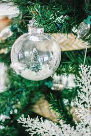 Diy Snow Globe Ornament Fill A Clear Ornament With A Bottle Brush Tree Clear Christmas Ornaments Christmas Globes Snow Globe Crafts