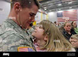 Vermont National Guard Spc. Matthew Bouchard, of Morrisville, Vt., holds  his daughter Avery, 6, during a homecoming ceremony