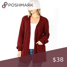 Classic lapel collar, front button chic 1970's burgundy wool ribbed and cable knit fitted cardigan with silver and gold plated ferragamo logo buttons down the front. Burgundy Wine Popcorn Cardigan Clothes Design Open Knit Cardigan Chunky Cable Knit Cardigan