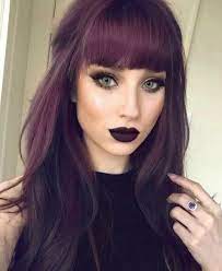 Hair is pulled into a high puff with curly bangs left outfrom: Pin On Happy Hair