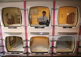A Visitor Relaxes In A Sleeping Module At Tokyo S Tube Hotel Capsule Capsule Hotel Pod Hotels Unique Hotels
