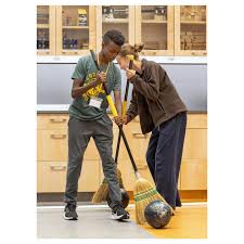 In Matt Dilley's Grade 9 Physics class, students participated in a bowling  ball and broom relay race yesterday. Using broom bristles, they guided a  bowling ball across the floor of their Annex