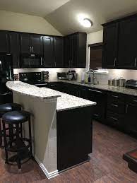 Warm and inviting kitchen with dark cherry cabinets with walnut stain. Santa Cecilia Granite And Dark Cabinets Home Decor Kitchen Home Kitchen Design