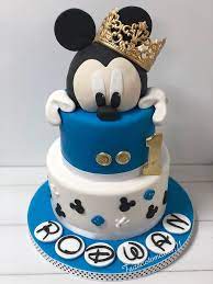 Decide on the entertainment 7. Blue And White Fondant Covered Two Tier Mickey Mouse Clubhouse Cake Golden One And Crown On Top Mickey Cakes Mickey Mouse Cake Mickey Mouse Birthday Cake