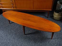 The design is both ethereal and practical: Vintage Walnut Surfboard Coffee Table By Mersman Design Market