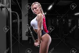 Attractive Busty Girl Working Out In A Crossover. Fitness And Bodybuilding  Concept. Mixed Media Stock Photo, Picture and Royalty Free Image. Image  168863156.